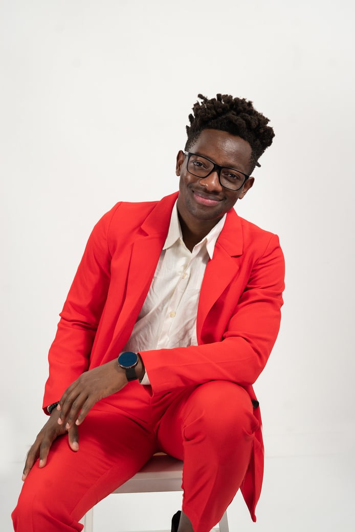 Portrait of a Man in Red Suit Sitting on Chair